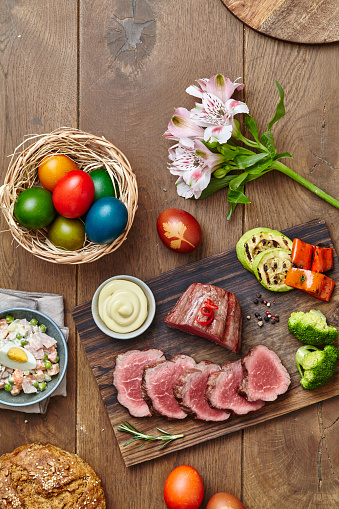 Beef stake lunch served with salad and easter eggs, top view with a space for copy
