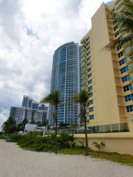 istock Modern apartment buildings with palm trees at Miami - view from road 1416420738