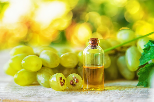 Grape seed oil in a bottle. Selective focus. Nature.