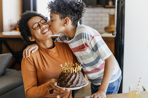 African-American mother and her son celebrating a birthday at home