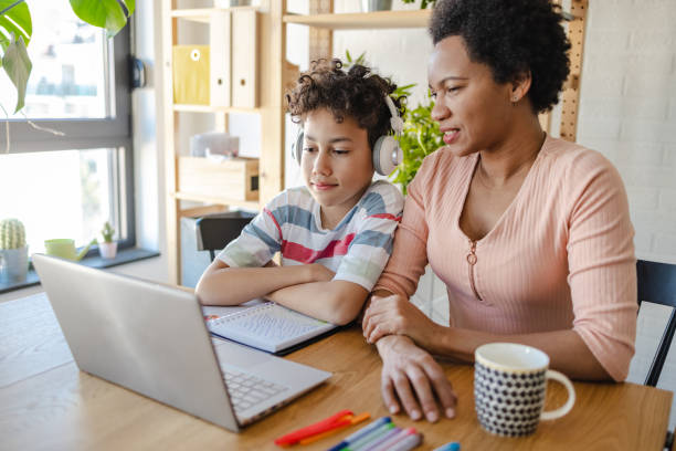 istock Mother helps her son to finish his homework 1416449148
