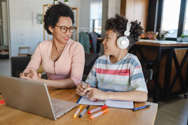 istock Mother helps her son to study at home 1416449400
