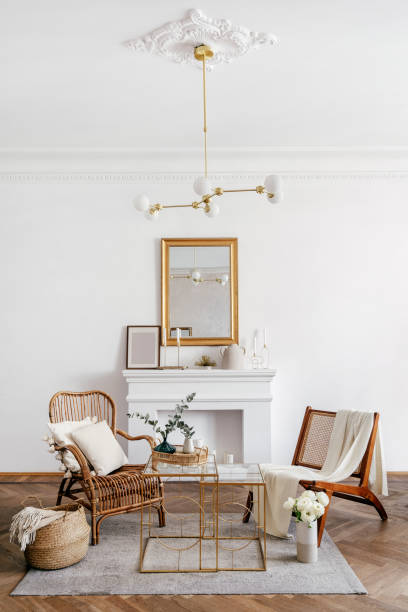 istock Wicker armchairs against decorative fireplace in living room 1416450650