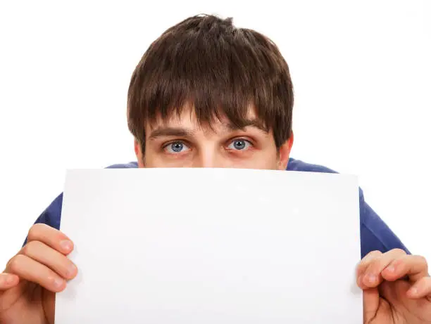 Surprised Young Man with Blank Paper Isolated on the White Background