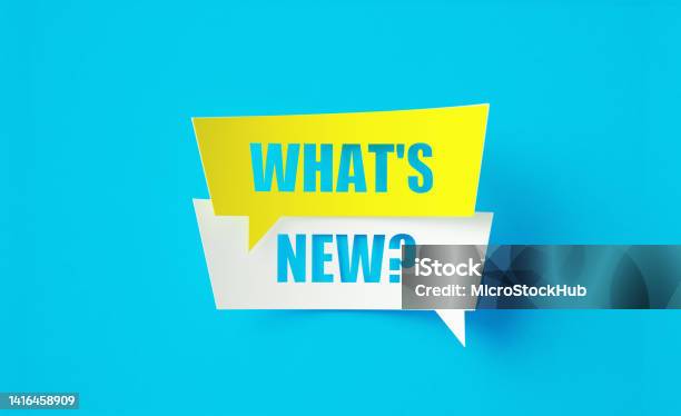 Whats New Written Cut Out Yellow And White Speech Bubbles Sitting Over Blue Background Stock Photo - Download Image Now