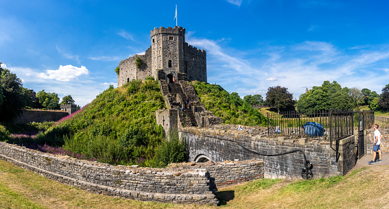 Cardiff Castle in the daytime an iconic landmark surrounded by parklands. People are visible in the image