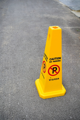 No parking sign in yellow traffic cone