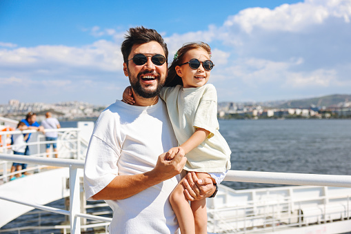 Daughter and Father Enjoy on the Ferry Boat Deck in Sunny Day Traveling on Vacation