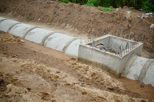 Concrete drainage pipe and manhole on Road construction site