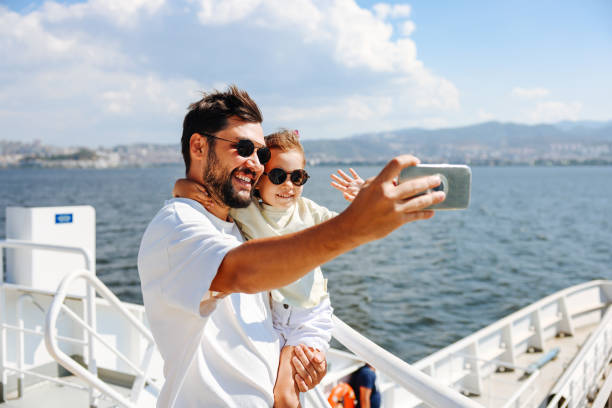 Daughter and Father Enjoy on the Ferry Boat Deck in Sunny Day Traveling on Vacation