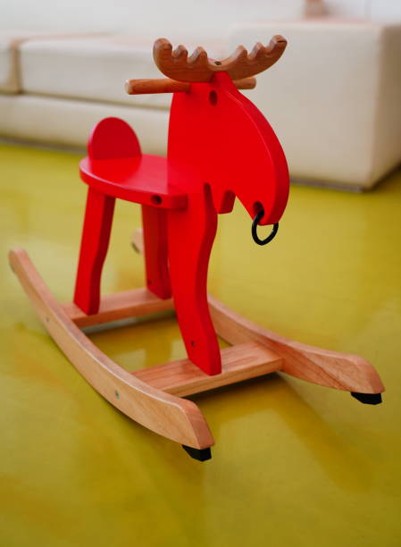 Wooden toy horse on a background of white lace. Copy space.