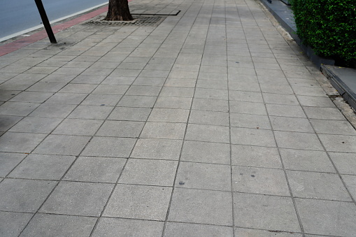 A sidewalk block made of rectangular bricks