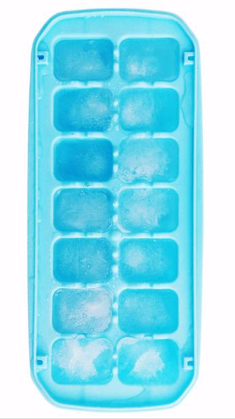 Ice cube tray with frozen cubes on white background stock photo
