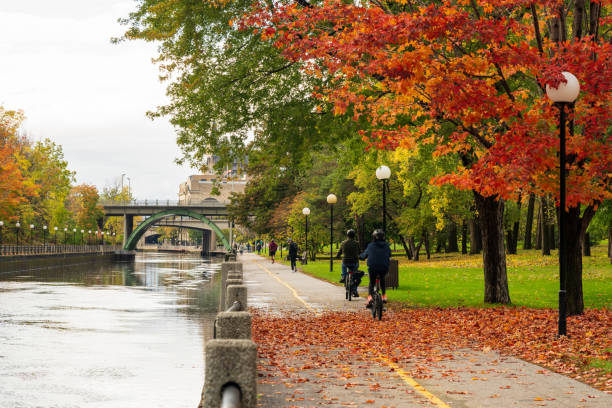 People cycling and walking in Rideau Canal Eastern Pathway. Autumn scenery in Ottawa stock photo