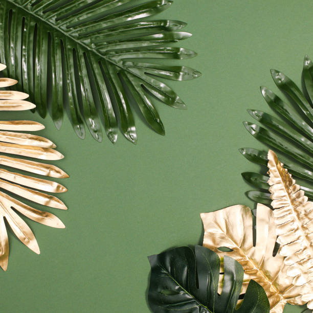 istock Summer exotic palm leaves on green background. Flat lay 1416488113