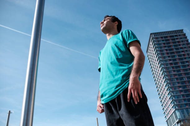 istock Young mixed race man is doing exercise with a bar in a London Park 1416498957
