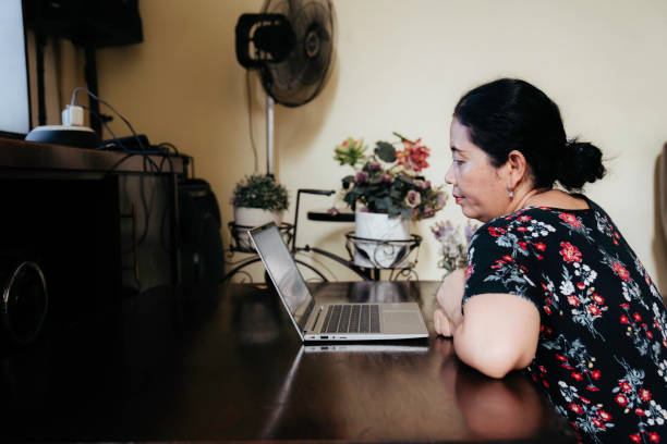 istock mature adult using laptop sitting on floor 1416502524