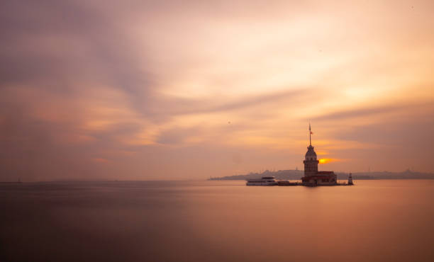 istock Fiery sunset over Bosphorus with famous Maiden's Tower (Kiz Kulesi) also known as Leander's Tower, symbol of Istanbul, Turkey. Scenic travel background for wallpaper or guide book 1416502673