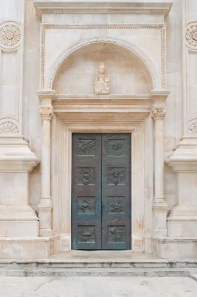 Facade of the old church with the metal door in Hvar town, Croatia, famous travel destination