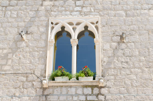 Window of an old stone house in Bol town on Brac, Croatia, Venetian Gothic style, architectural detail