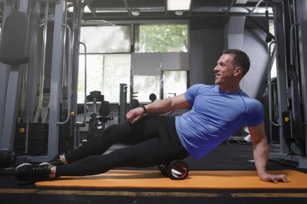 istock Male athlete using foam roller at the gym 1416505149