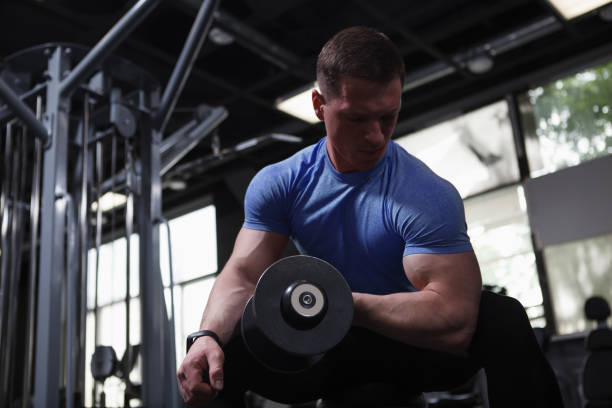 istock Male bodybuilder exercising with dumbbells 1416507427