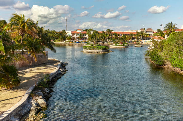 Paradisiac residential area in Riviera Maya, Mexico. Residential area of Puerto aventuras in mexico, with luxurious private homes overlooking the waterway that leads directly to the sea and the beach. puerto aventuras stock pictures, royalty-free photos & images