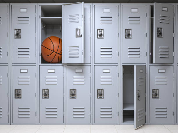 School or gym locker room with small lockers box insuficient for basketball ball. stock photo