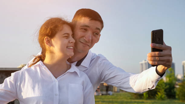 istock Young disabled couple makes selfies grimacing to smartphone 1416538212