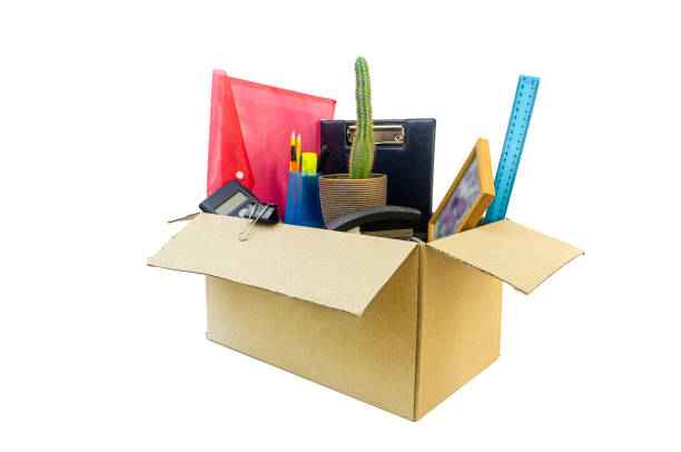istock Cardboard box full of office stuff on white background 1416538538