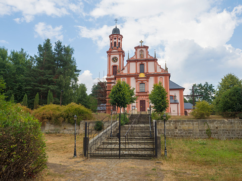 Pink and white baroque church of saint Mary Magdalene in Marenice, Czech Republic, sunny summer day, vibrant colors
