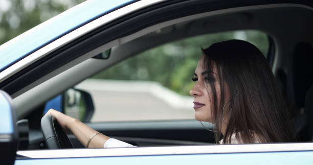 istock Angry woman explodes with negativity hitting wheel in car 1416547016