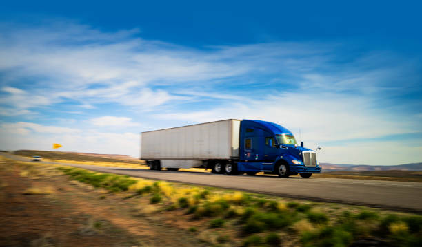 istock Blue and white semi-truck speeding 1416548656