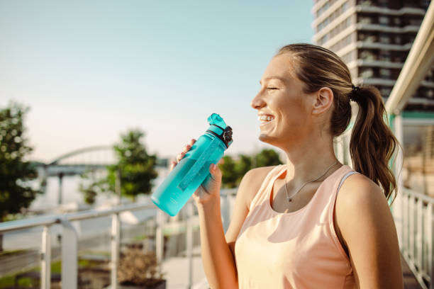 istock Young woman refreshing herself after her sports training 1416553762