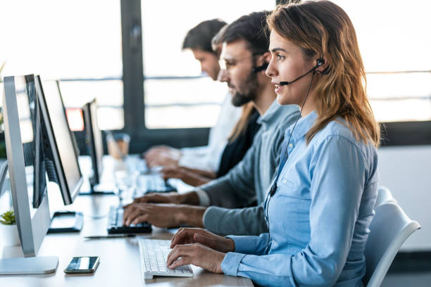 equipo de negocios concentrado exitoso que trabaja junto con computadoras en el lugar de coworking. - back office fotografías e imágenes de stock