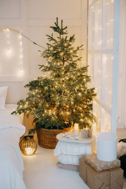 istock Decorated mirror and live Christmas tree with lights. New year's interior, festive atmosphere, decor, garlands, gifts 1416554757