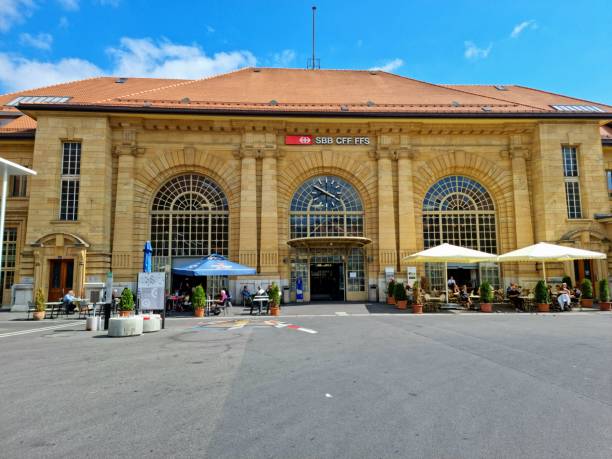 La Chaux-de-Fonds with several pedestrians at the main Railway Station. La Chaux-de-Fonds has a population of 38,000 inhabitants and it is located in the french part of switzerland. The image was captured during summer season.