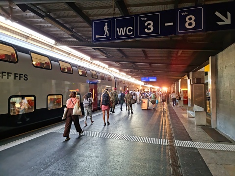Lausanne with a train at the railroad platform. The image was captured at dusk during summer season.