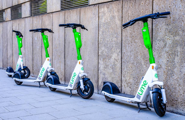 modern eScooter at a street Munich, Germany - June 27: typical modern eScooters at a street in the old town of Munich on June 27, 2022 lime scooter stock pictures, royalty-free photos & images