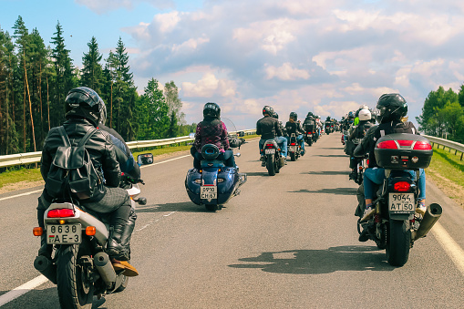 Group of motorcyclists rides on asphalt country road on summer sunny day. Parade of motorcycles - Lida, Belarus: August 26, 2017.