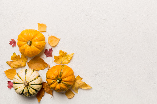 Autumn composition. Pattern made of dried leaves and other design accessories on table. Flat lay, top view.