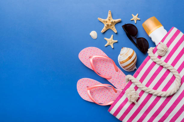 istock beach accessories flat lay top view on colored background Summer travel concept. Bag with starfish and sea shell. Top view 1416575904