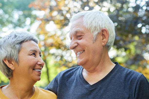 istock Optimistic attractive elderly 60s couple pose in park 1416589008