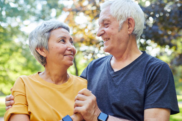 istock Optimistic attractive multiracial elderly 60s couple pose outdoors 1416589013