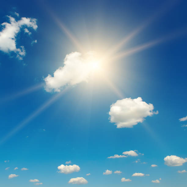 istock Blue sky with fluffy clouds and bright sun 1416589257
