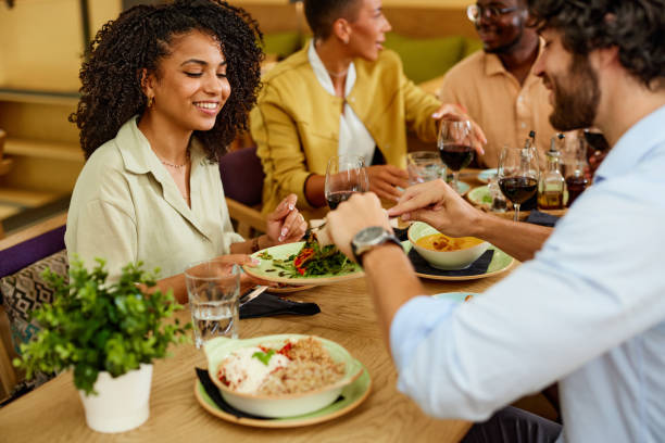 A Group of friends has dinner together in a restaurant. stock photo