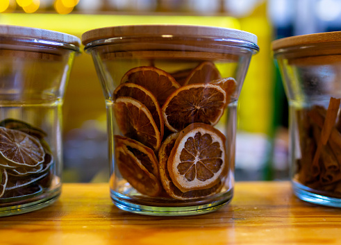 bar counter and glass jar close-up with dry sliced lemons