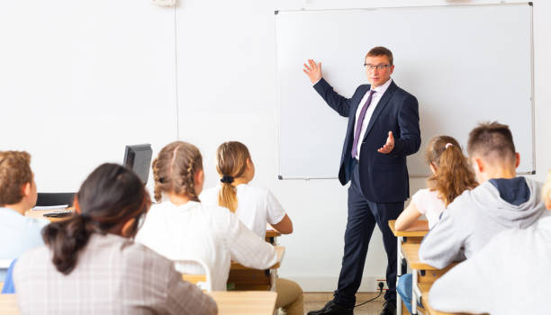 istock Adult teacher is giving lecture for students in class 1416600135