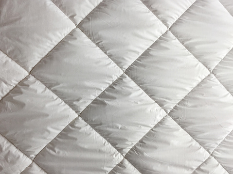 Full frame front view white bedding sheets duvet quilt texture