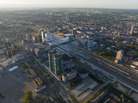 Utrecht skyline and central station public transport infrastructure and business district. Aerial drone overhead view. Tall buildings and towers downtown.